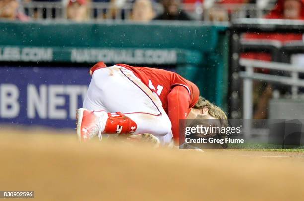 Bryce Harper of the Washington Nationals on the ground in pain after injuring his leg in the first inning against the San Francisco Giants at...