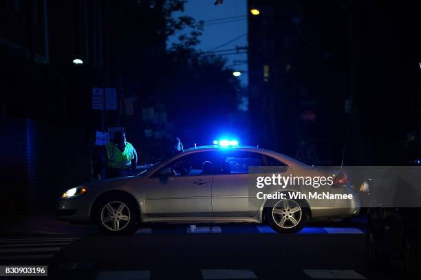 Police block streets near the location were a woman was killed and multiple people were injured when a car plowed into a crowd of anti-fascist...