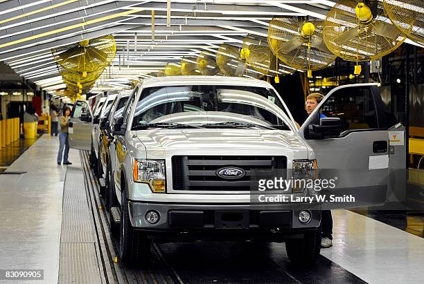 Employees work on the final assembly line for the F-150 pickup at the Kansas City Ford Assembly plant October 2, 2008 in Claycomo, Missouri. Ford's...