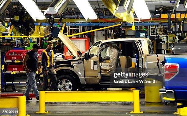 Employees walk across the assembly line of the F-150 pickup at the Kansas City Ford Assembly plant October 2, 2008 in Claycomo, Missouri. Ford's...