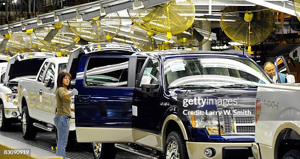 Janna Dake, a Ford inspector for 20 years, works the final assembly line for the F-150 pickup at the Kansas City Ford Assembly plant October 2, 2008...