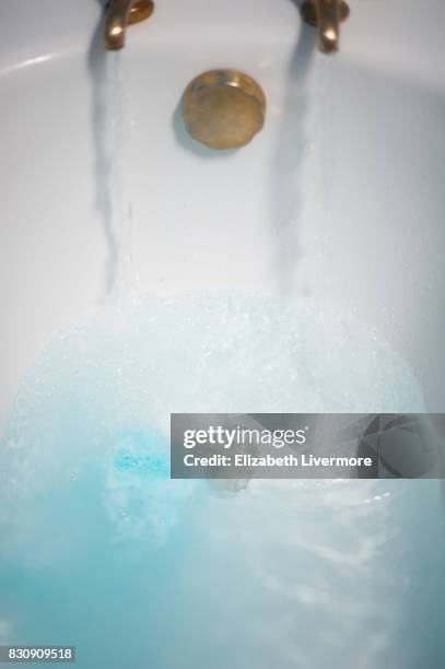 bath running with blue bath bomb - bath bomb stock pictures, royalty-free photos & images