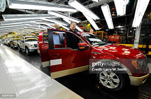 Joe Hinrichs, VP of Global Mfg. And Labor Affairs and Gregory Armstrong, a 17-year Ford employee, stand in the doors of a Ford F-150 Lobo pickup on...