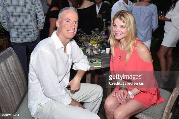 Jon LoPresti and Gwendolyn Beck attend AVENUE on the Beach's Summer Soiree at The Baker House on August 12, 2017 in East Hampton, New York.