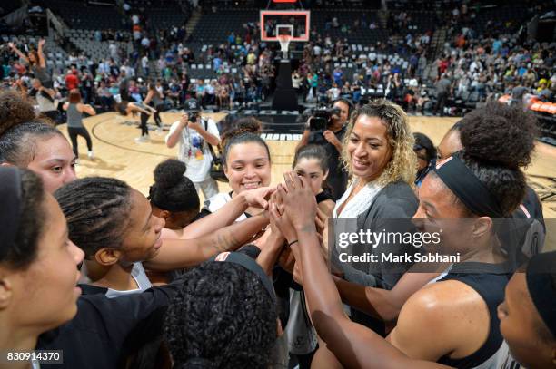 Erika de Souza and Kayla McBride of the San Antonio Stars with their teammates celebrate a win against the Atlanta Dream on August 12, 2017 at the...