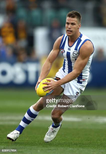 Andrew Swallow of the Kangaroos runs with the ball during the round 21 AFL match between the Hawthorn Hawks and the North Melbourne Kangaroos at...