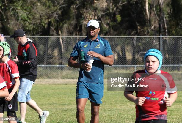 Kurtley Beale gives water to the junior teams during an Australian Wallabies fan day on August 13, 2017 in Penrith, Australia.