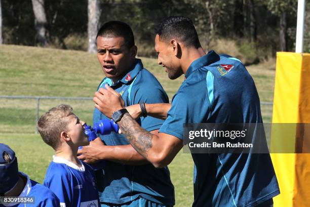 Israel Folau gives water to the junior players during an Australian Wallabies fan day on August 13, 2017 in Penrith, Australia.