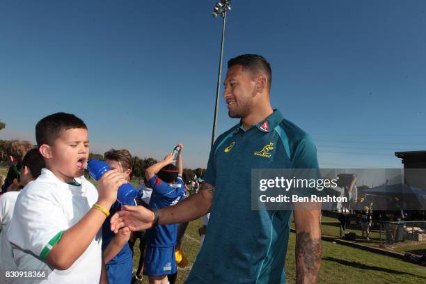 Israel Folau gives water to the junior players during an Australian Wallabies fan day on August 13, 2017 in Penrith, Australia.