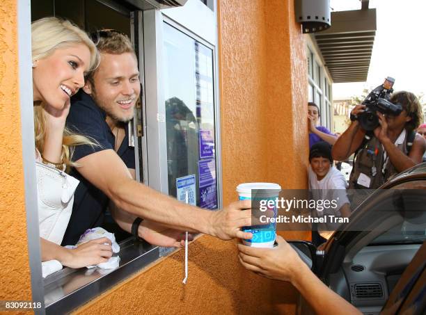 Heidi Montag and Spencer Pratt serve customers at the drive-up window to the "Reality Check Challenge" held at Taco Bell on October 2, 2008 in Los...