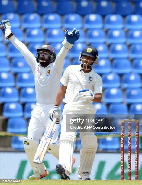 Sri Lanka's wicketkeeper Niroshan Dickwella successfully appeals against India's Kuldeep Yadav during the second day of the third and final Test...