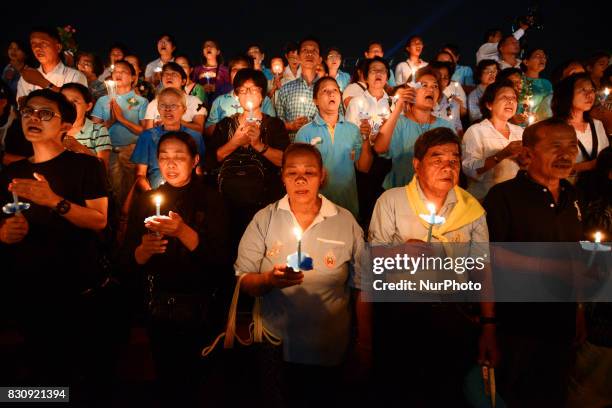 Thai people hold up candles during the birthday of Thailand's Queen Sirikit at Bangkok, Thailand, 12 August 2017.