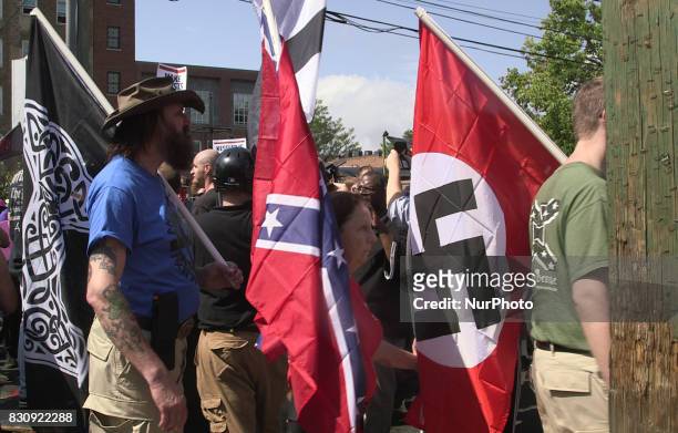 Demonstrators carry confederate and Nazi flags during the Unite the Right free speech rally at Emancipation Park in Charlottesville, Virginia, USA on...