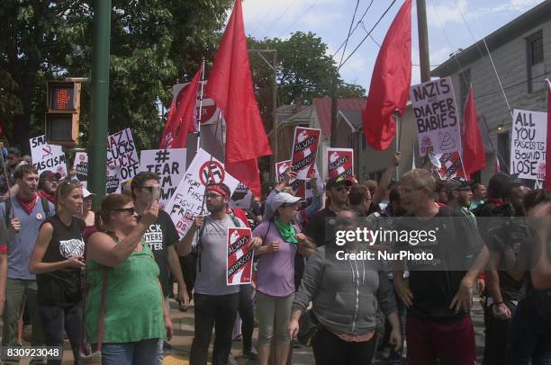 Protesters carry signs and flags during the Unite the Right free speech rally at Emancipation Park in Charlottesville, Virginia, USA on August 12,...