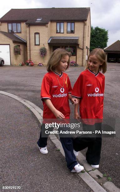 Two child actors, playing Jessica Chapman, left, and Holly Wells, leave Redhouse Gardens as they take part in a police reconstruction, in Soham,...