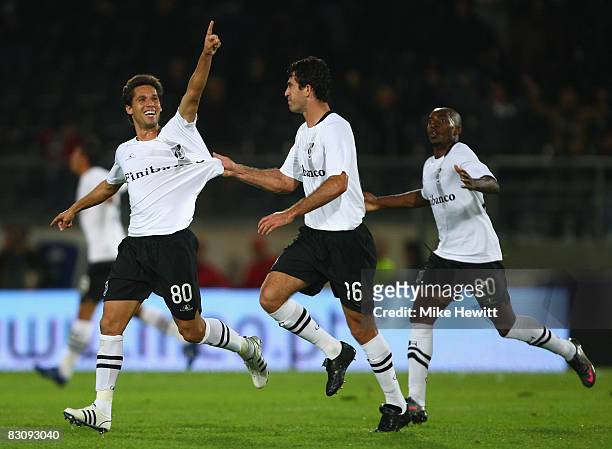 Joao Alves of Vitoria Guimaraes is chased by team mates Danilo and Desmarets after scoring during the UEFA Cup Ist round 2nd leg match between...