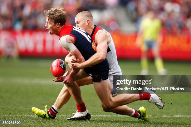 Mitch Hannan of the Demons is tackled by Sebastian Ross of the Saints during the round 21 AFL match between the Melbourne Demons and the St Kilda...