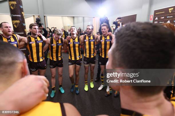 The Hawks celebrate after they defeated the Kangaroos during the round 21 AFL match between the Hawthorn Hawks and the North Melbourne Kangaroos at...