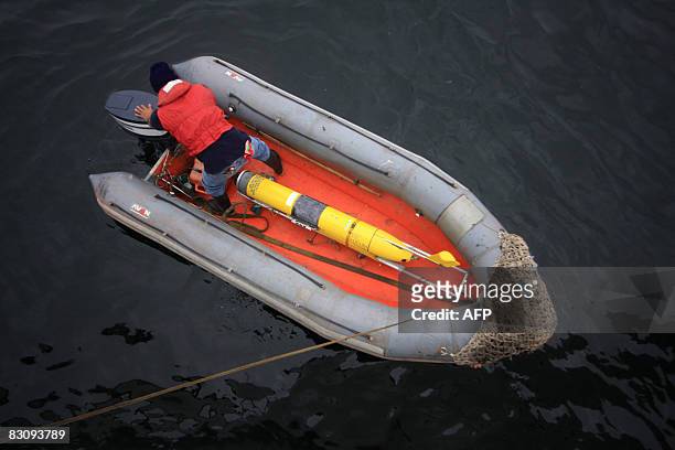Member of the Peruvian Navy gets ready to launch a glider , a submarine robot operated via satellite, into the sea on October 2, 2008 as part of a...