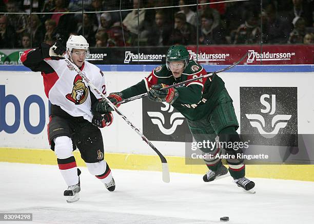 Antoine Vermette of the Ottawa Senators battles for puck possession against Patric Blomdahl of the Frolunda Indians at Scandinavium Arena on October...