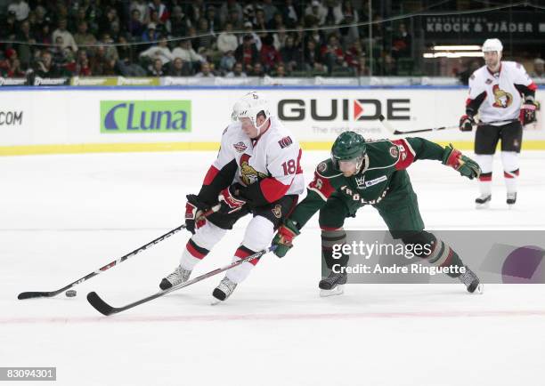 Jesse Winchester of the Ottawa Senators stickhandles the puck away from a stick check by Toni Soderholm of the Frolunda Indians at Scandinavium Arena...