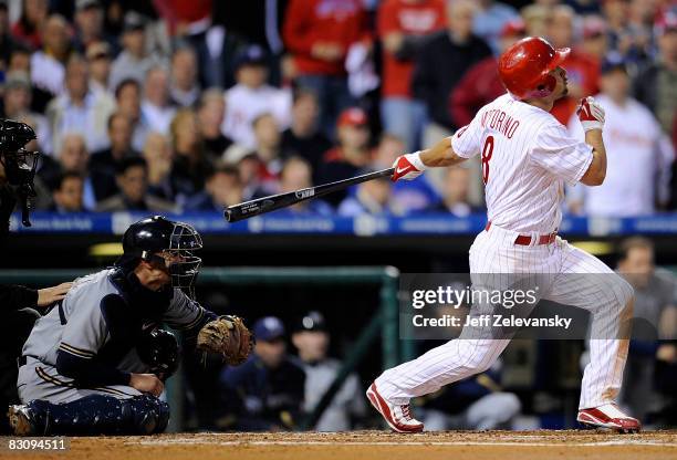 Shane Victorino of the Philadelphia Phillies hits a grand slam in front of Jason Kendall of the Milwaukee Brewers in the second inning of Game 2 of...