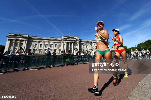 Ines Henriques of Portugal and Hang Yin of China walk in front of Buckingham Palace in the Women's 50km Race Walk final during day ten of the 16th...