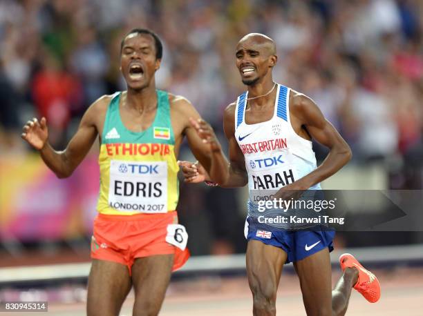 Muktar Edris of Ethiopia and Mohamed Farah of Great Britain cross the finish line in the Men's 5000 Metres final during day nine of the 16th IAAF...