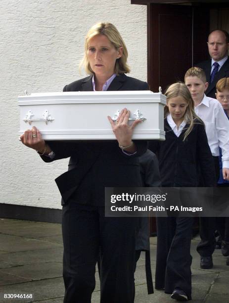 Detective Sergeant Lindsay McNair carries the tiny white coffin of Baby Carrie, from an interdenominational service on the outskirts of Belfast,...