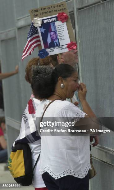 Woman observes a minute's silence at Ground Zero in New York at the first anniversary of the terrorist attacks on the World Trade Center.