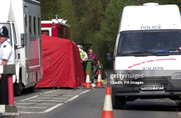 Police clearing up after the forensic teams at the police road block near Yateley Heath in Hampshire, where the remains of missing schoolgirl Amanda...