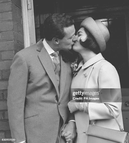 Patrick MacNee kisses his bride Catherine Woodville after their wedding at Hampstead, London.