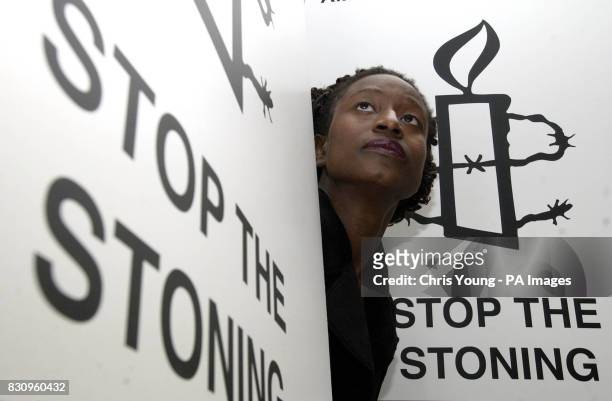 Amnesty International's Adjoa Owusu from London stands outside the city's Nigerian High Commission to deliver a petition of nearly 1.3 million...