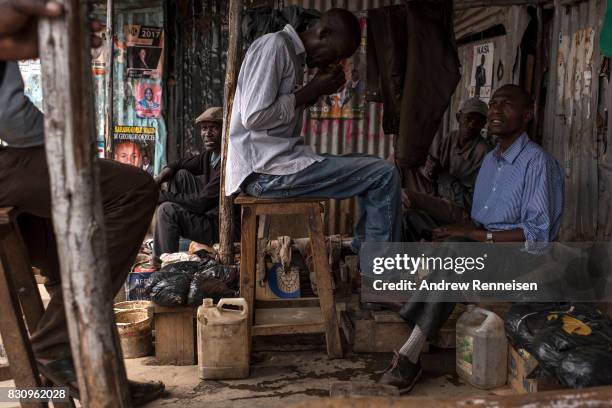 Man gets his shoes shined in the Kibera slum on August 13, 2017 in Nairobi, Kenya. A day prior, demonstrations turned violent in some areas...