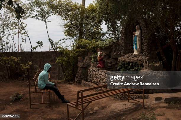 Woman prays inside the grounds of Our Lady of Guadalupe Parish in the Kibera slum on August 13, 2017 in Nairobi, Kenya. A day prior, demonstrations...