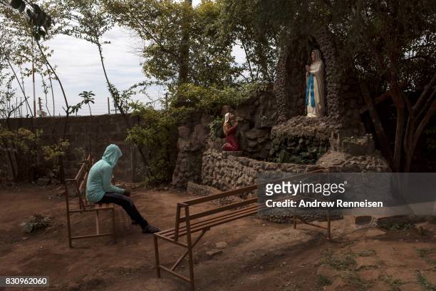 Woman prays inside the grounds of Our Lady of Guadalupe Parish in the Kibera slum on August 13, 2017 in Nairobi, Kenya. A day prior, demonstrations...