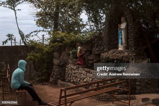 Woman prays inside the grounds of Our Lady of Guadalupe Parish in the Kibera slum on August 13, 2017 in Nairobi, Kenya. A day prior, demonstrations...