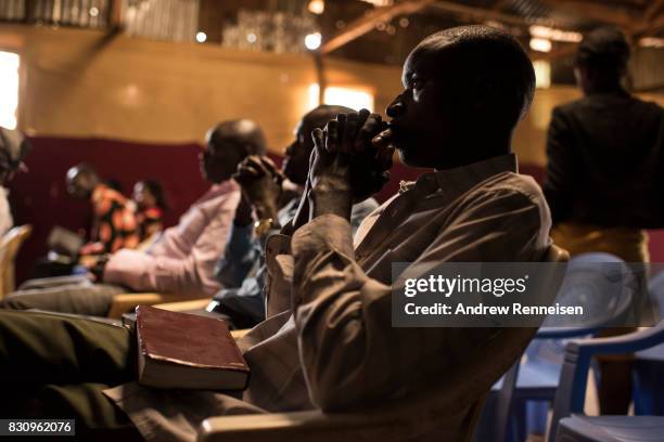 People pray during Sunday service at Fullgospel Evangelistic Ministry in the Kibera slum on August 13, 2017 in Nairobi, Kenya. A day prior,...