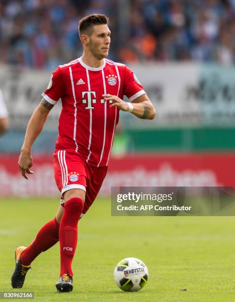 Munich's defender Niklas Suele plays the ball during the German football Cup DFB Pokal first round match between German third division football club...