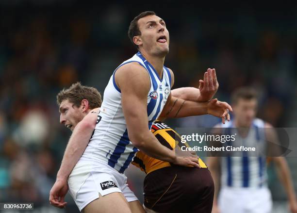 Braydon Preuss of the Kangaroos and Ben McEvoy of the Hawks compete for the ball during the round 21 AFL match between the Hawthorn Hawks and the...