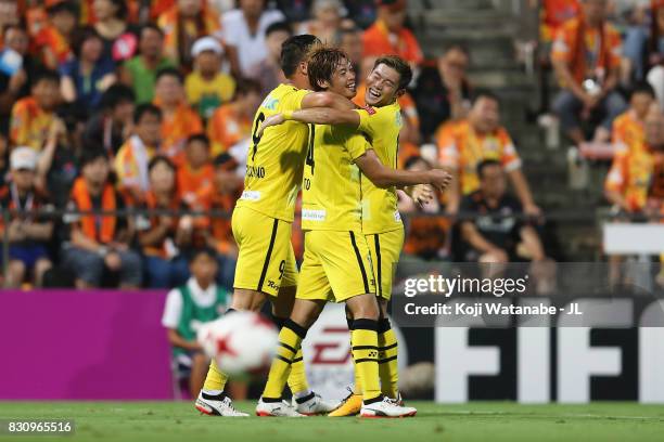 Junya Ito of Kashiwa Reysol celebrates scoring the opening goal with his team mates Cristiano and Ryuta Koike during the J.League J1 match between...