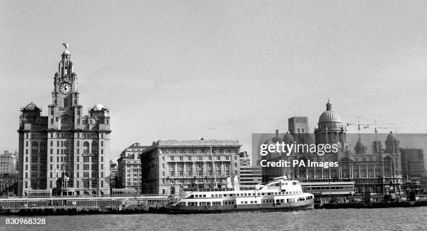 Royal Liver Building in Liverpool, left, with the Mersey ferry on its way along the River Mersey.
