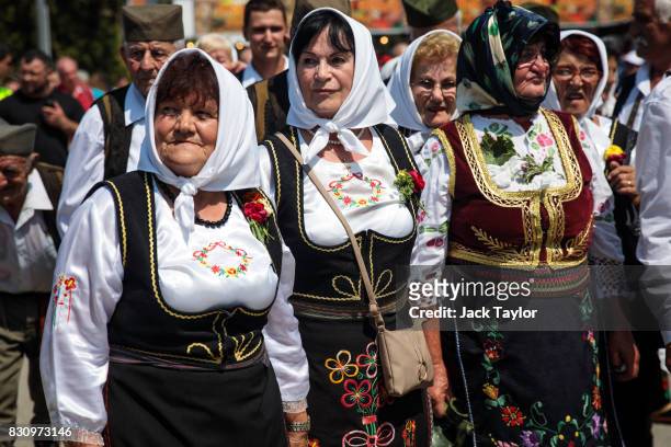 Group of Serbians in traditional dress parade through the town during the Guca Trumpet Festival on August 12, 2017 in Guca, Serbia. Thousands of...