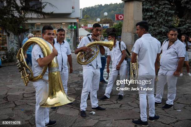 Brass band looks on during the Guca Trumpet Festival on August 10, 2017 in Guca, Serbia. Thousands of revellers attend the trumpet festival, held...