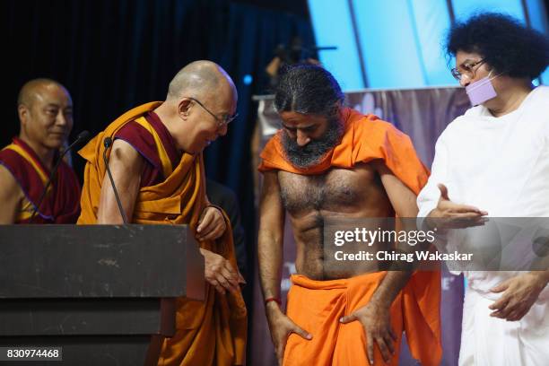 His Holiness The 14th Dalai Lama with Yoga guru Baba Ramdev World Peace & Harmony Conclave at NSCI Dome on August 13, 2017 in Mumbai, India.