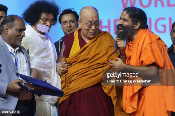 His Holiness The 14th Dalai Lama with Yoga guru Baba Ramdev World Peace & Harmony Conclave at NSCI Dome on August 13, 2017 in Mumbai, India.