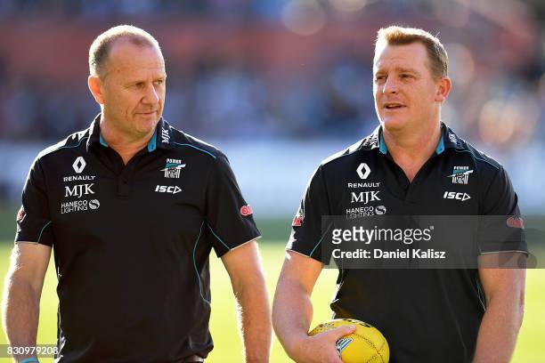 Ken Hinkley the coach of the Power and Michael Voss midfield manager of the Power walk from the field during the round 21 AFL match between Port...
