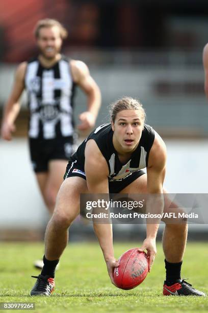 Gus Borthwick of Collingwood gathers the ball during the round 16 VFL match between the Collingwood Magpies and North Ballarat at Victoria Park on...