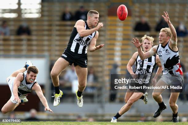 Brayden Sier of Collingwood handballs during the round 16 VFL match between the Collingwood Magpies and North Ballarat at Victoria Park on August 13,...