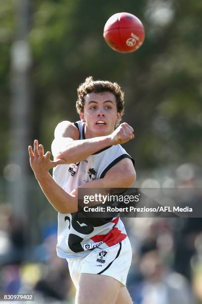 Flynn Appleby of North Ballarat handballs during the round 16 VFL match between the Collingwood Magpies and North Ballarat at Victoria Park on August...